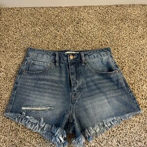 Dark wash Jean shorts with rip on the right side. Size 27